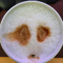 a cappuccino whose foam looks like a sad face — my profile picture